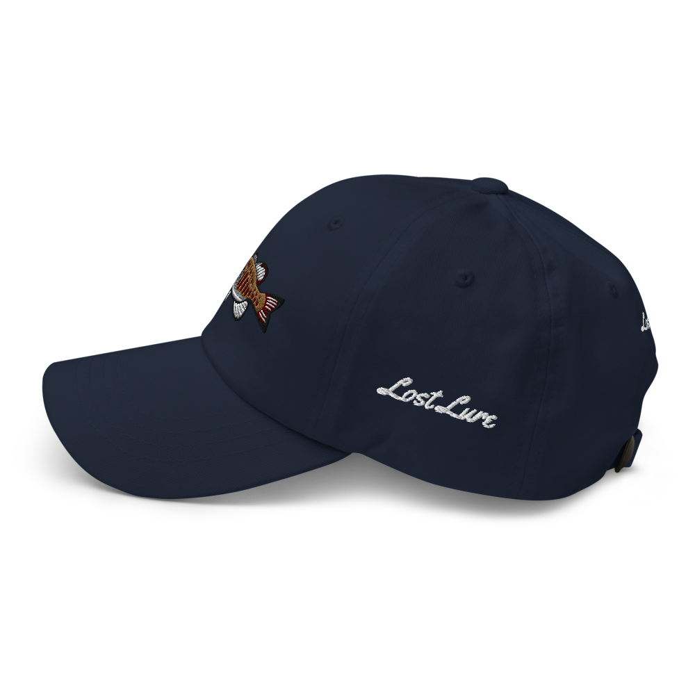 A smallmouth bass fishing hat / dad hat with a simple embroidery design of a smallie. Blue hat, front left side.