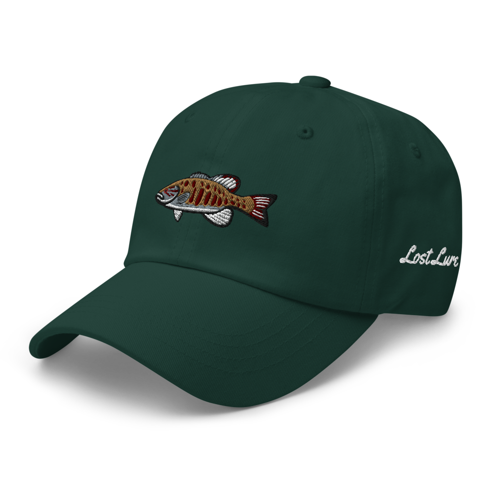 A smallmouth bass fishing hat / dad hat with a simple embroidery design of a smallie. Green hat, front left side