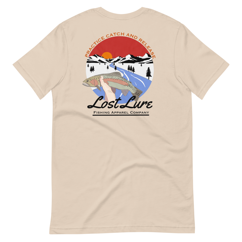 Lost Lure Fishing T-shirt with design that reads “practice catch and release” it has a rainbow trout being released in a river in snowy mountains. Light brown shirt, back side
