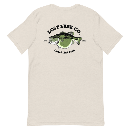 Bass fishing shirt. It has a drawing of a fat bass and it reads “lost lure co, catch fat fish”. The bass design is on the back, the lost lure logo is on the front. Tan shirt, back side